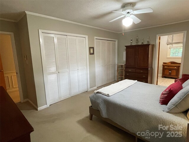103 Boyd Dr, Stanley, NC 28164 - carpeted bedroom with multiple closets, baseboards, crown molding, and a ceiling fan