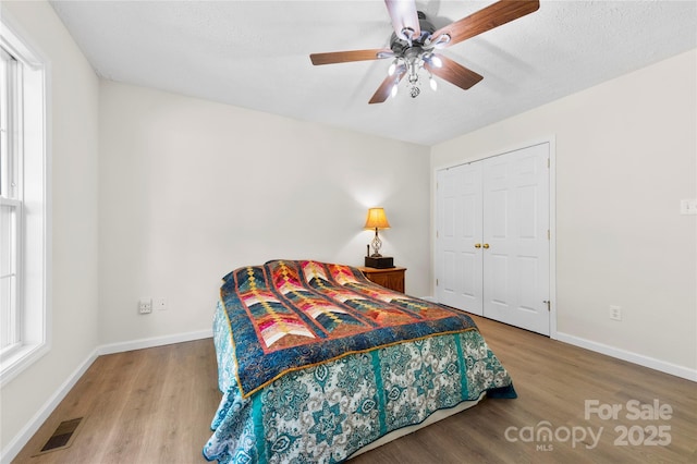 55 Gilbert B Crook Rd, Candler, NC 28715 - bedroom with wood finished floors, a closet, and ceiling fan