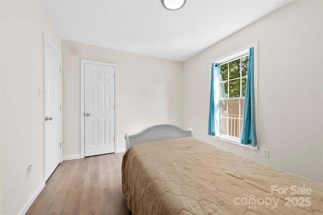 55 Gilbert B Crook Rd, Candler, NC 28715 - bedroom featuring wood finished floors and baseboards