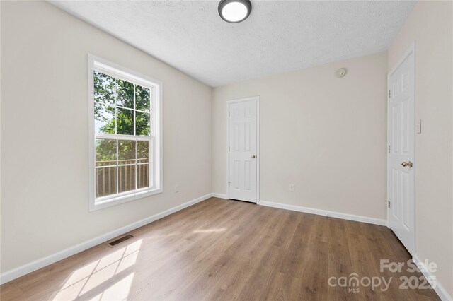 55 Gilbert B Crook Rd, Candler, NC 28715 - unfurnished bedroom with wood finished floors and a textured ceiling