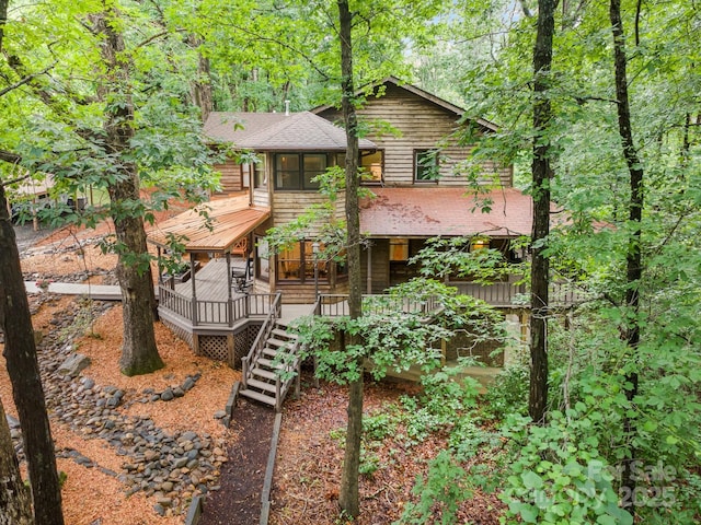 676 Cottingham Pl NE, Concord, NC 28025 - view of front of home with stairs, a shingled roof, a deck, and a sunroom