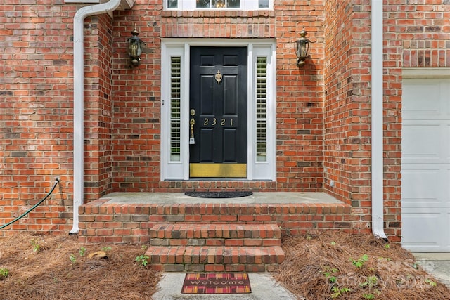 2321 Oberwood Dr, Charlotte, NC 28270 - doorway to property featuring brick siding and an attached garage