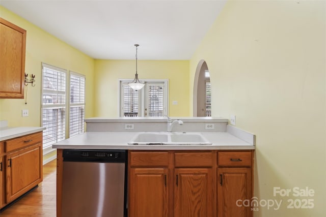 2321 Oberwood Dr, Charlotte, NC 28270 - kitchen featuring stainless steel dishwasher, a peninsula, light countertops, and arched walkways