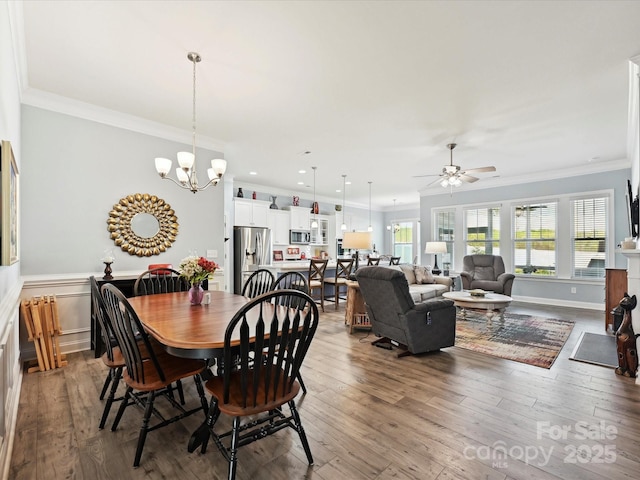 177 Yellow Birch Loop, Mooresville, NC 28117 - dining area featuring ornamental molding, a ceiling fan, a chandelier, wood finished floors, and a wainscoted wall