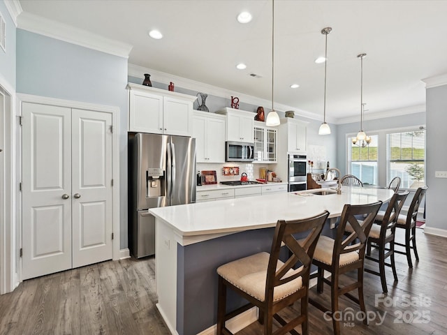 177 Yellow Birch Loop, Mooresville, NC 28117 - kitchen with stainless steel appliances, a large island with sink, a sink, white cabinets, and ornamental molding