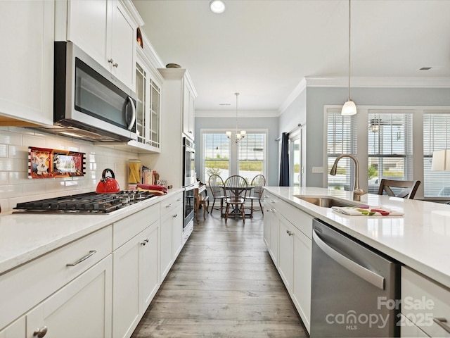177 Yellow Birch Loop, Mooresville, NC 28117 - kitchen with stainless steel appliances, a sink, light countertops, tasteful backsplash, and ornamental molding