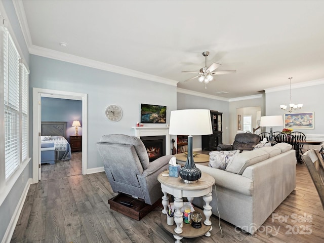 177 Yellow Birch Loop, Mooresville, NC 28117 - living area featuring ceiling fan, a lit fireplace, crown molding, wood finished floors, and a chandelier