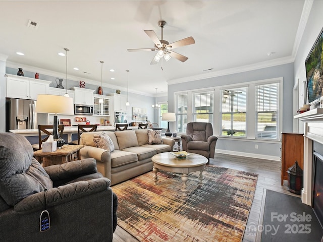 177 Yellow Birch Loop, Mooresville, NC 28117 - living area featuring dark wood-style flooring, ceiling fan, ornamental molding, baseboards, and a fireplace with flush hearth