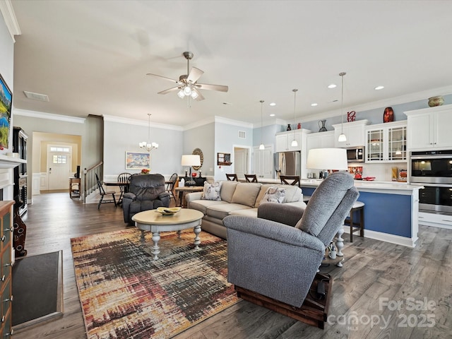 177 Yellow Birch Loop, Mooresville, NC 28117 - living area with ceiling fan, dark wood finished floors, a chandelier, crown molding, and a fireplace