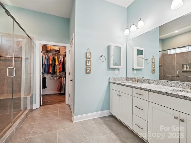 177 Yellow Birch Loop, Mooresville, NC 28117 - bathroom with double vanity, a shower stall, tile patterned flooring, and a walk in closet