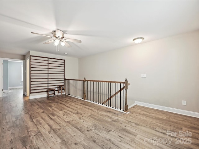 177 Yellow Birch Loop, Mooresville, NC 28117 - spare room with wood finished floors, a ceiling fan, and baseboards