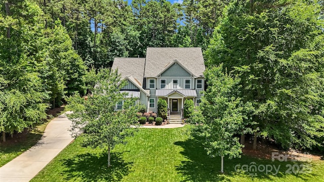 6422 Northern Red Oak Dr, Mint Hill, NC 28227 - craftsman-style house featuring a front yard, board and batten siding, a standing seam roof, a shingled roof, and a metal roof