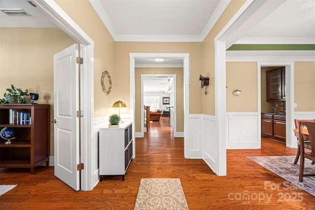 6422 Northern Red Oak Dr, Mint Hill, NC 28227 - hall featuring wood finished floors, crown molding, and a wainscoted wall