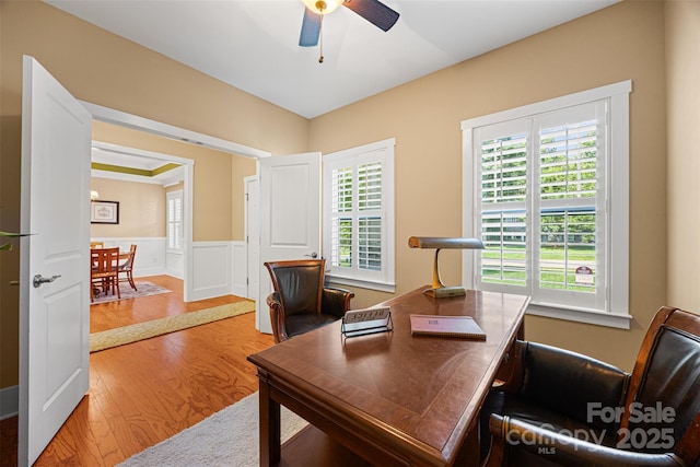 6422 Northern Red Oak Dr, Mint Hill, NC 28227 - home office featuring wood finished floors, ceiling fan, a wainscoted wall, and a decorative wall