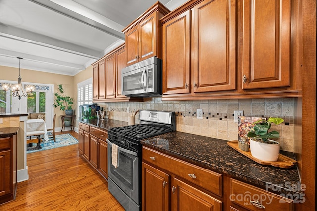 6422 Northern Red Oak Dr, Mint Hill, NC 28227 - kitchen featuring stainless steel appliances, beam ceiling, a chandelier, light wood-style flooring, and brown cabinetry