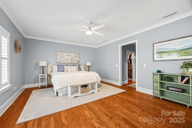 6422 Northern Red Oak Dr, Mint Hill, NC 28227 - bedroom featuring wood finished floors, ornamental molding, multiple windows, and a ceiling fan