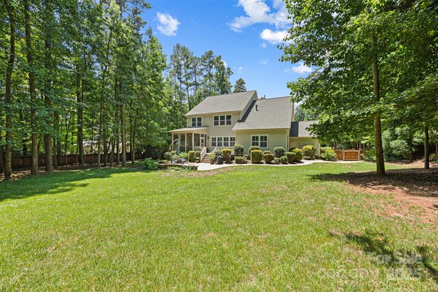 6422 Northern Red Oak Dr, Mint Hill, NC 28227 - rear view of property featuring a sunroom, a patio area, and a shingled roof