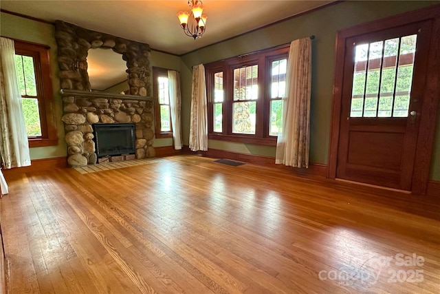 4320 Pisgah Dr, Canton, NC 28716 - unfurnished living room featuring a fireplace, wood finished floors, plenty of natural light, and crown molding
