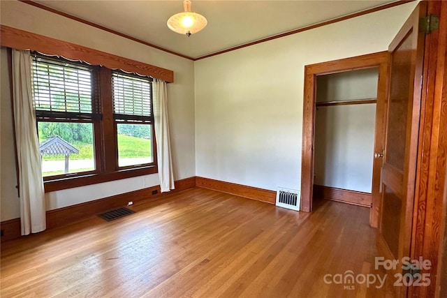 4320 Pisgah Dr, Canton, NC 28716 - unfurnished bedroom featuring crown molding, light wood-style floors, and baseboards