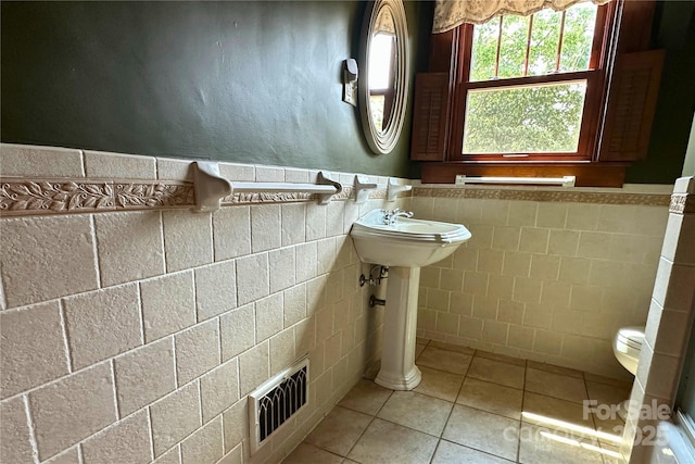4320 Pisgah Dr, Canton, NC 28716 - bathroom featuring tile walls, tile patterned flooring, wainscoting, and toilet