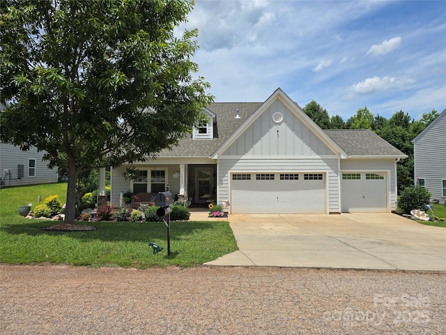 16115 Commodore Dr, Lancaster, SC 29720 - view of front of property featuring board and batten siding, a garage, a front yard, concrete driveway, and covered porch