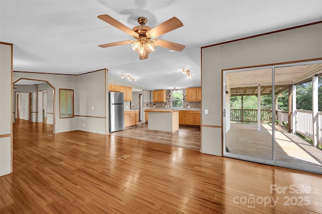1532 Buffalo Shoals Rd, Claremont, NC 28610 - unfurnished living room featuring light wood-style flooring, a ceiling fan, and crown molding
