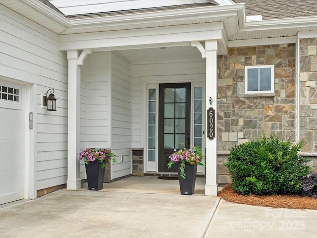 6020 Waldorf Ave, Monroe, NC 28110 - view of exterior entry featuring stone siding and a shingled roof