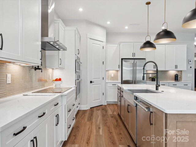6020 Waldorf Ave, Monroe, NC 28110 - kitchen featuring wall chimney range hood, stainless steel appliances, decorative backsplash, wood finished floors, and recessed lighting