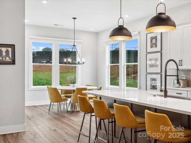 6020 Waldorf Ave, Monroe, NC 28110 - kitchen featuring a chandelier, light countertops, healthy amount of natural light, decorative light fixtures, and recessed lighting