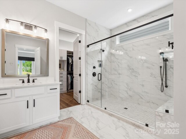 6020 Waldorf Ave, Monroe, NC 28110 - full bath with a marble finish shower, marble look tile flooring, vanity, and a spacious closet