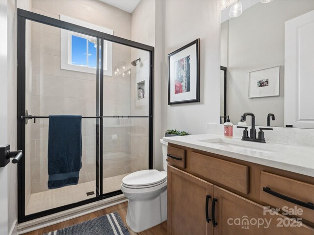 6020 Waldorf Ave, Monroe, NC 28110 - full bathroom with wood finished floors, vanity, and a stall shower
