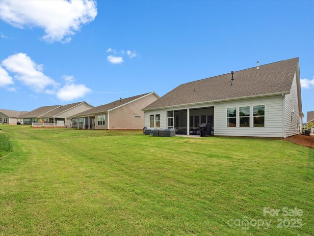 6020 Waldorf Ave, Monroe, NC 28110 - rear view of house with a lawn, a sunroom, and roof with shingles