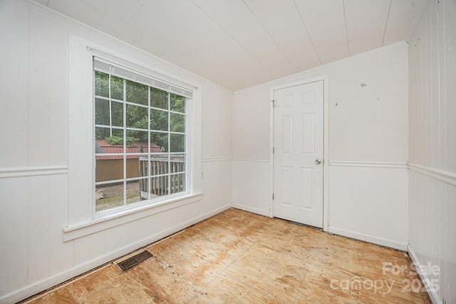 158 John Crotts Rd, Mocksville, NC 27028 - spare room featuring crown molding, wooden walls, and baseboards