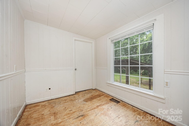 158 John Crotts Rd, Mocksville, NC 27028 - empty room with wood finished floors, healthy amount of natural light, ornamental molding, and wooden walls