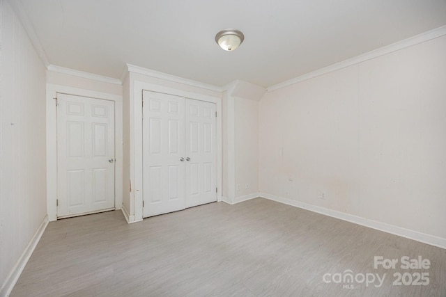 158 John Crotts Rd, Mocksville, NC 27028 - unfurnished bedroom featuring wood finished floors, baseboards, ornamental molding, and a closet