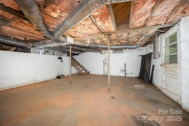 158 John Crotts Rd, Mocksville, NC 27028 - basement featuring electric water heater, stairs, electric panel, and concrete block wall