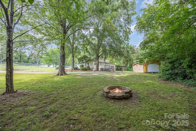 158 John Crotts Rd, Mocksville, NC 27028 - view of green lawn featuring an outdoor fire pit and an outdoor structure