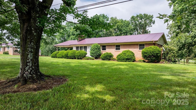4214 Horseshoe Bend Rd, Hudson, NC 28638 - single story home with a front yard, metal roof, a chimney, and brick siding