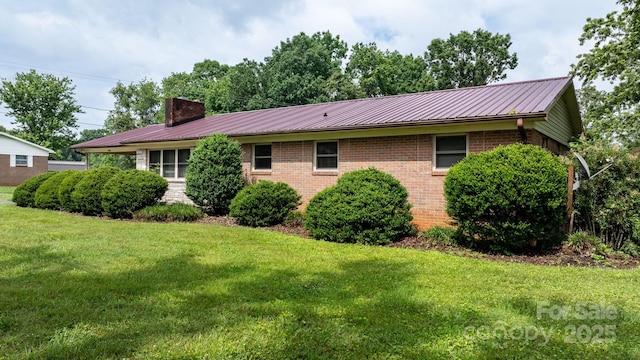 4214 Horseshoe Bend Rd, Hudson, NC 28638 - view of side of home with a chimney, brick siding, a lawn, and metal roof