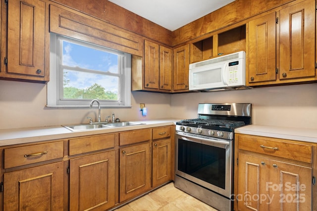 4214 Horseshoe Bend Rd, Hudson, NC 28638 - kitchen featuring gas range, white microwave, a sink, and brown cabinetry