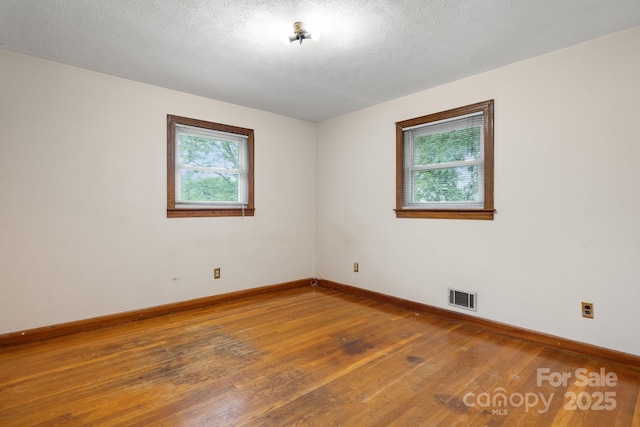 4214 Horseshoe Bend Rd, Hudson, NC 28638 - empty room featuring hardwood / wood-style floors, baseboards, and a textured ceiling