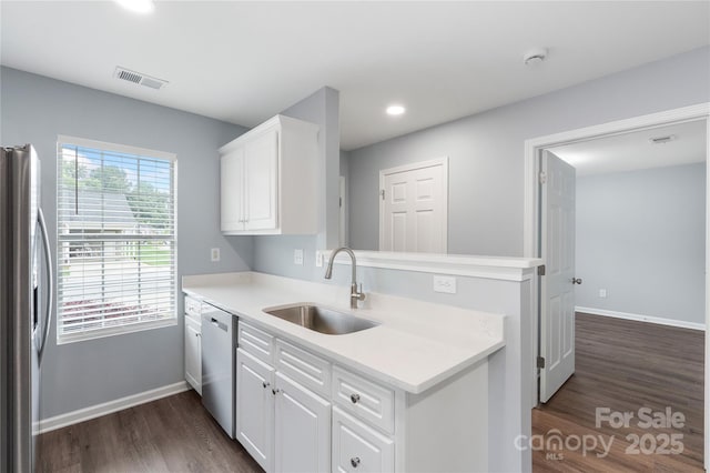 2045 Pin Oak Pl, Cramerton, NC 28032 - kitchen with appliances with stainless steel finishes, dark wood-style floors, white cabinetry, light countertops, and recessed lighting