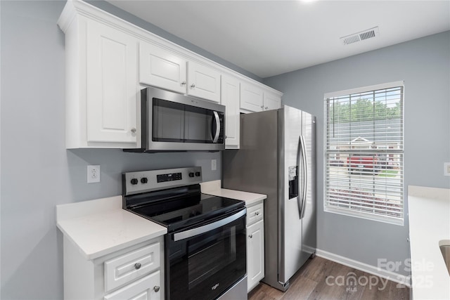 2045 Pin Oak Pl, Cramerton, NC 28032 - kitchen featuring appliances with stainless steel finishes, dark wood-type flooring, white cabinets, and light countertops