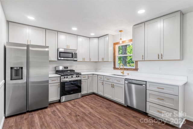 4980 Murray Rd, Winston Salem, NC 27106 - kitchen with stainless steel appliances, a sink, light countertops, dark wood-type flooring, and recessed lighting