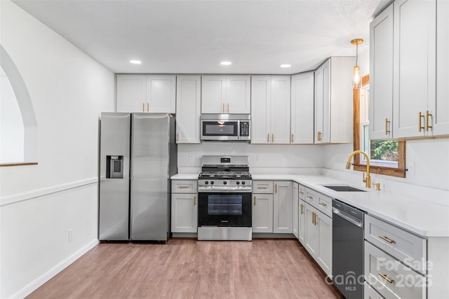 4980 Murray Rd, Winston Salem, NC 27106 - kitchen featuring appliances with stainless steel finishes, a sink, light wood-style flooring, light countertops, and recessed lighting