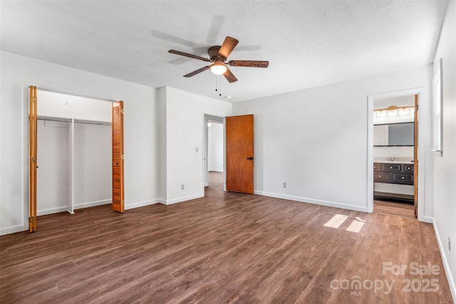 4980 Murray Rd, Winston Salem, NC 27106 - unfurnished bedroom featuring wood finished floors, baseboards, ensuite bath, and a ceiling fan