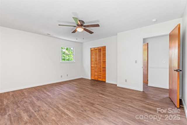 4980 Murray Rd, Winston Salem, NC 27106 - unfurnished bedroom featuring wood finished floors, baseboards, a closet, and a ceiling fan