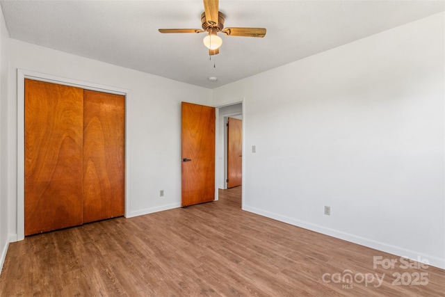 4980 Murray Rd, Winston Salem, NC 27106 - unfurnished bedroom with baseboards, wood finished floors, a closet, and ceiling fan