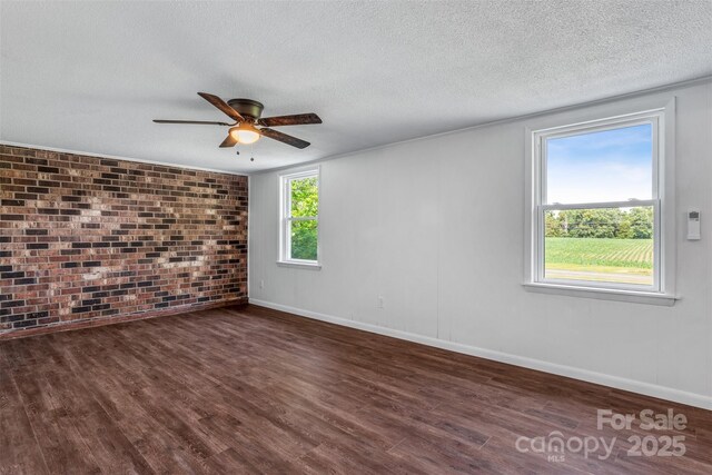 4980 Murray Rd, Winston Salem, NC 27106 - empty room featuring brick wall, wood finished floors, ceiling fan, baseboards, and a textured ceiling