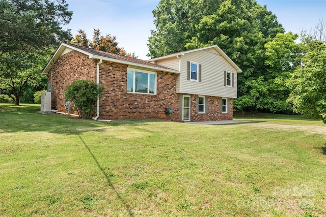 4980 Murray Rd, Winston Salem, NC 27106 - tri-level home with brick siding, a front yard, and a patio